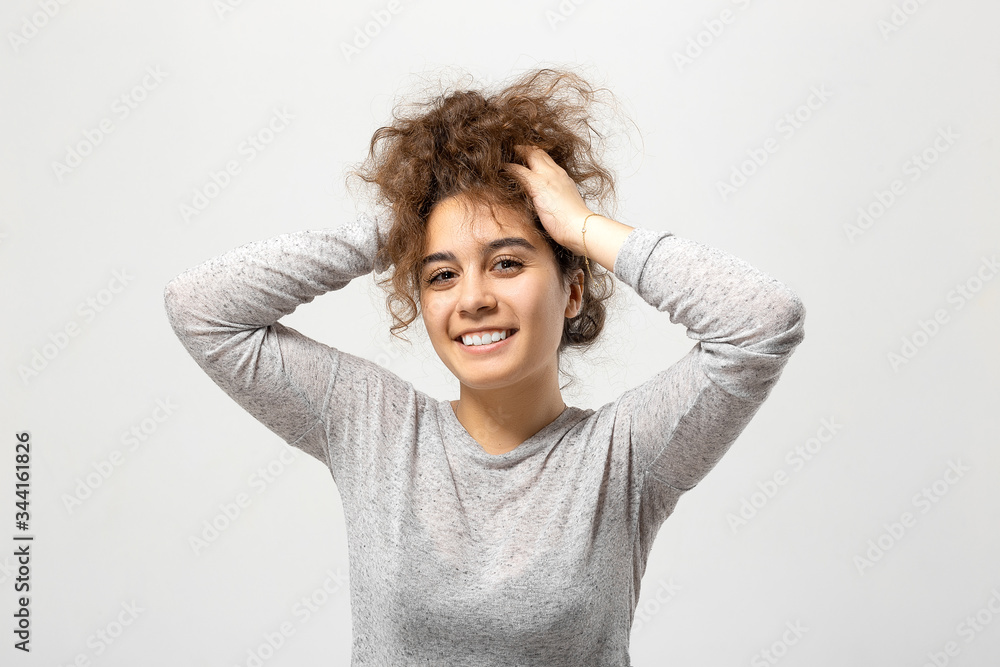 Beautiful young woman portrait. Indoor portrait of beautiful brunette young woman with shaggy hairstyle Beautiful young woman portrait. Indoor portrait of beautiful brunette young woman with shaggy hairstyle