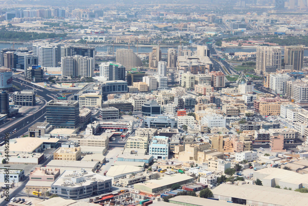 Obraz premium Aerial view of modern city with attractive buildings, Dubai Creek, Dubai, United Arab Emirates. Urban architecture viewed from airplane. Soft focus