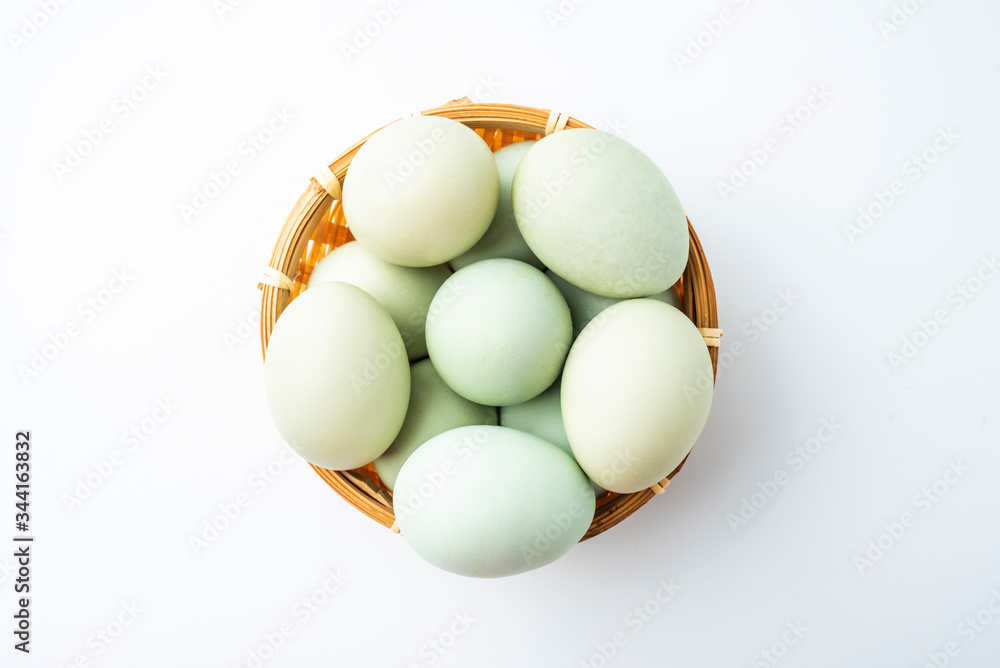 Black eggs in green shell on white background Black eggs in green shell on white background