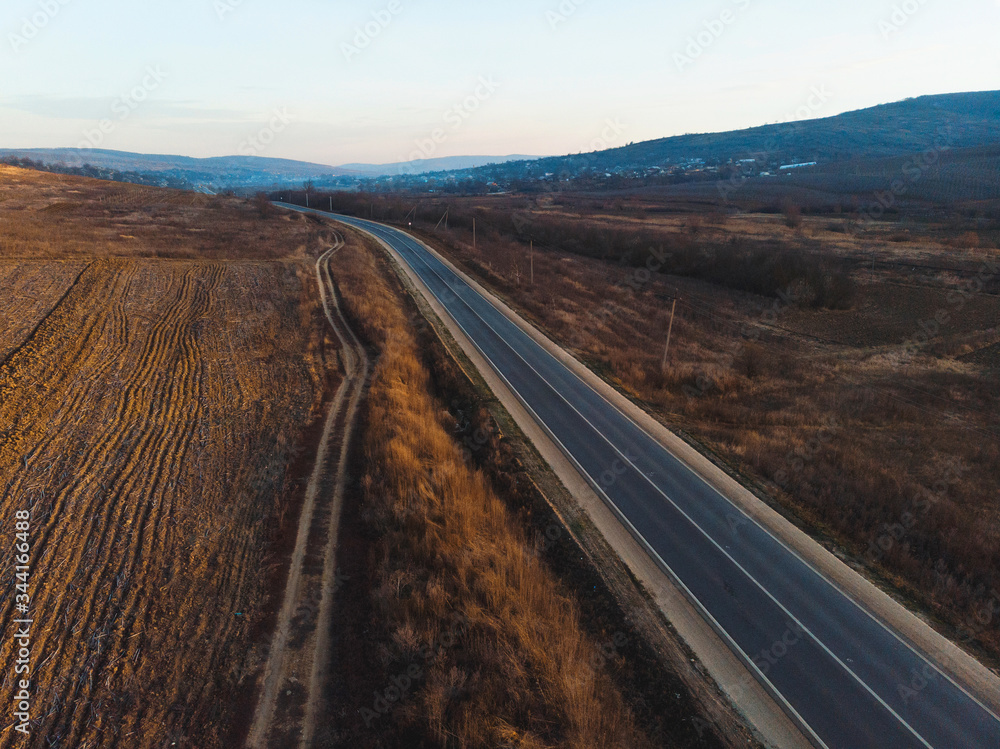 Fototapeta premium empty road between fields