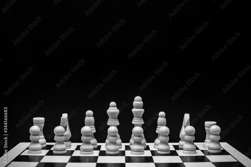 Chess pieces on the board with black background Chess pieces on the board with black background