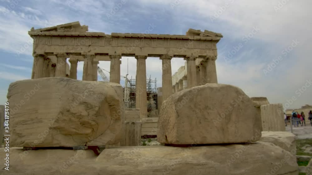 Tracking shot camera moves slowly behind stones and ruins of ancient parthenon acropolis in Athens Tracking shot camera moves slowly behind stones and ruins of ancient parthenon acropolis in Athens