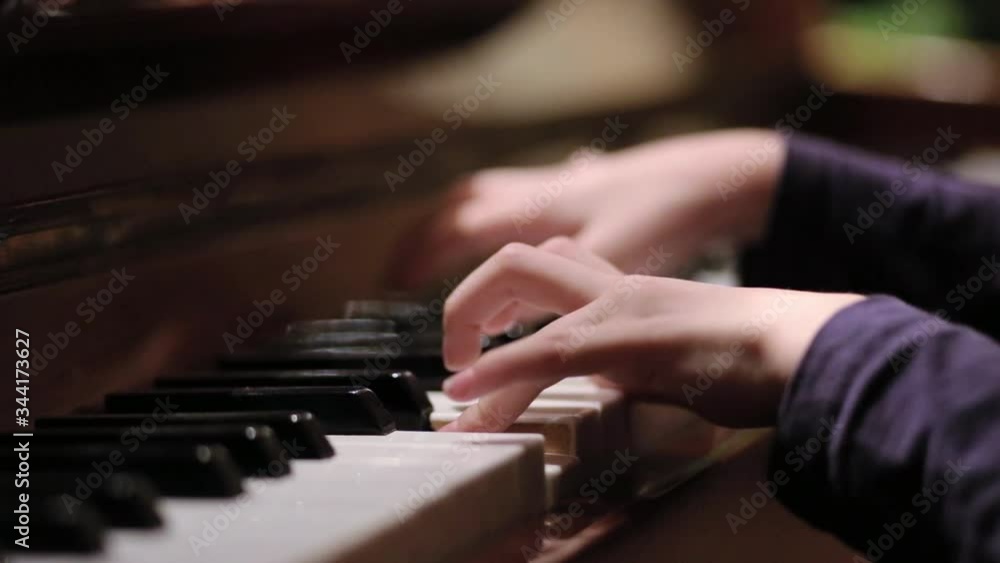 Young girl playing piano at home education. Young girl playing piano at home education.