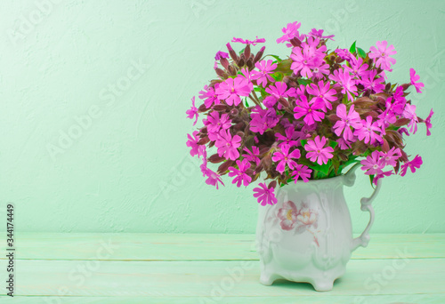 flowers in a vase on a wooden table photo