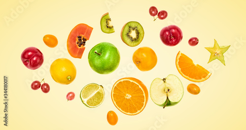 Flying fruits healthy summer color background. Papaya  orange  kiwi  melon. Levitation  falling fly fruit. Tropical creative concept. Colorful fruity summertime vivid design