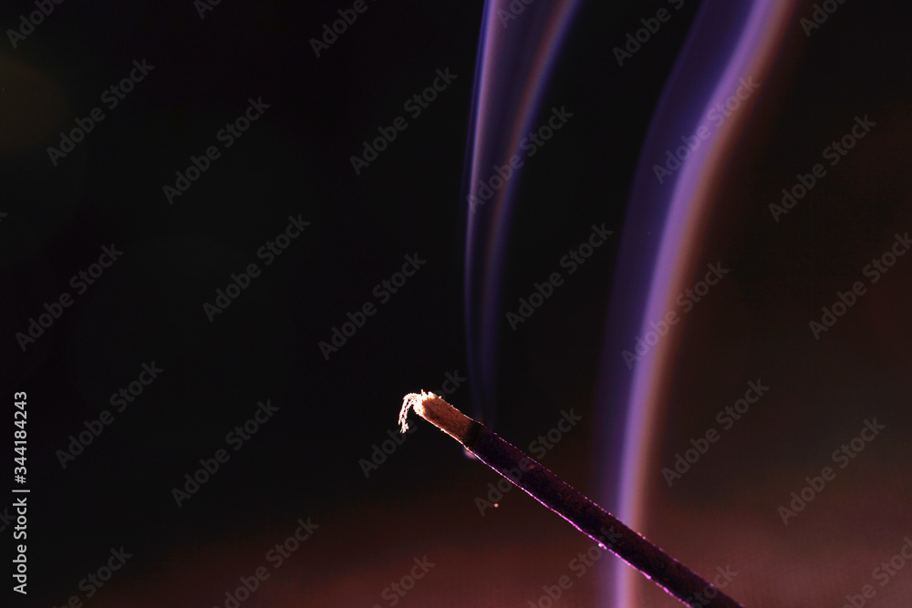 photograph the incense stick medium against a black background