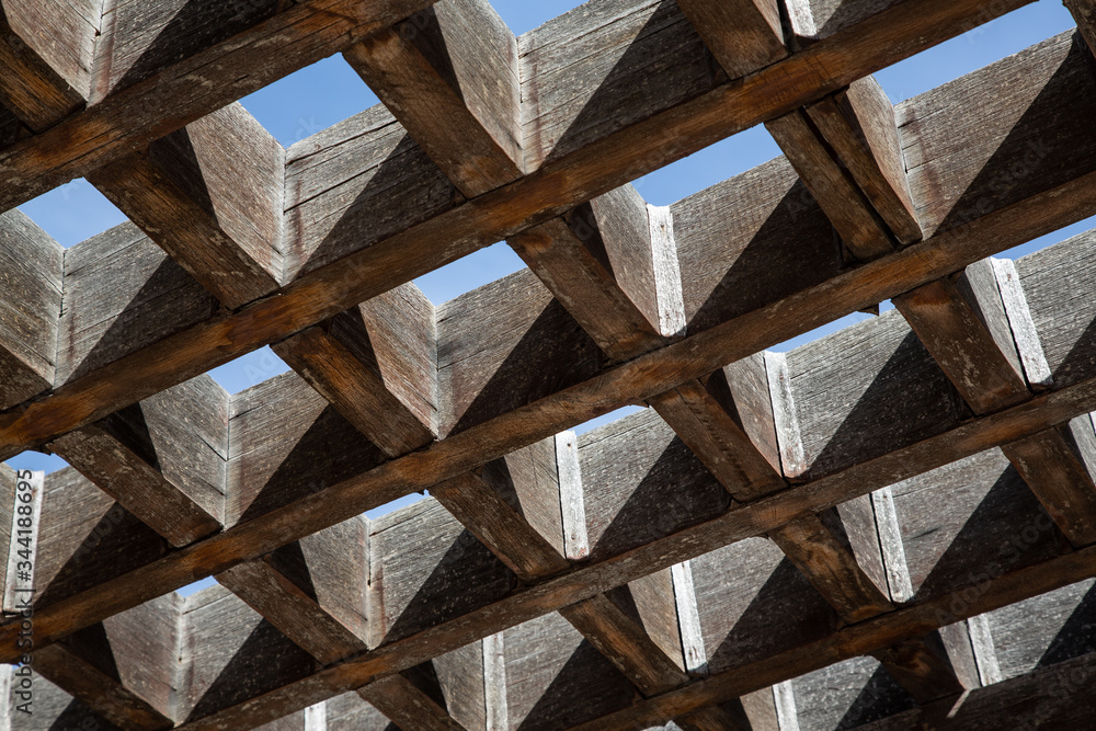 Wooden bars forming a shading grid seen from below