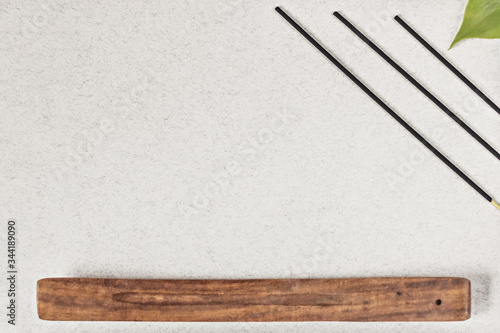 Incense sticks with a stand on a gray background. Aromatherapy. Spa home concept