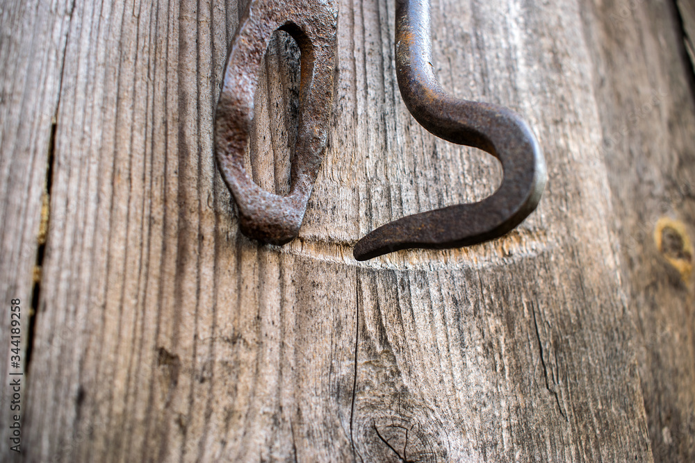 iron latch on the background of a wooden building iron latch on the background of a wooden building
