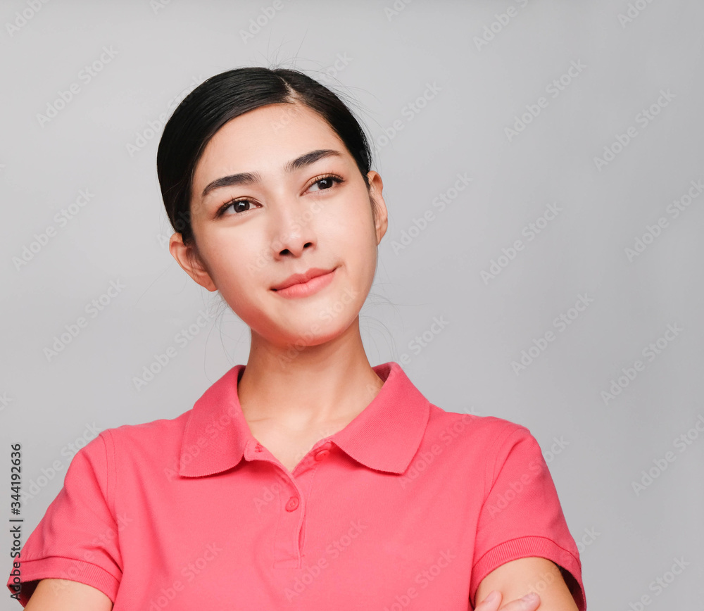 young beautiful asian woman wore pink t shirt, Showed thinking expression , on gray background young beautiful asian woman wore pink t shirt, Showed thinking expression , on gray background