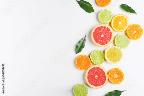 Sliced slices of citrus fruits laid out on a white table.