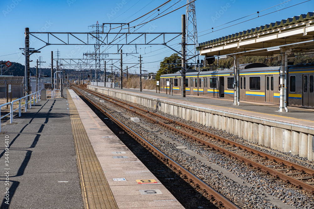 Japan, Beautiful view of Japanese railway train track, empty platform and local train in the background