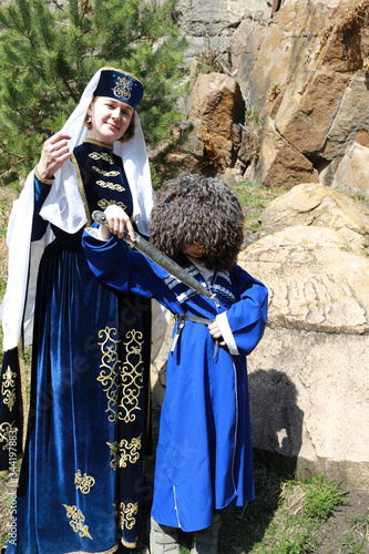 Mother with her son in traditional Karachai clothes photo