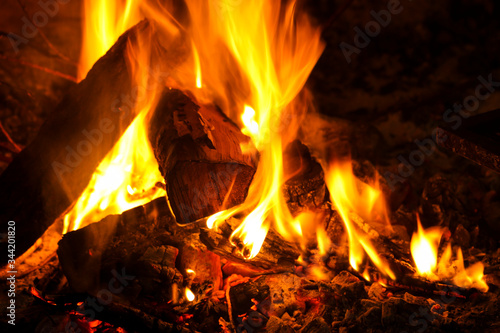 Lighted wood logs in a fireplace. Wood heating. Vegetable combustion heat.