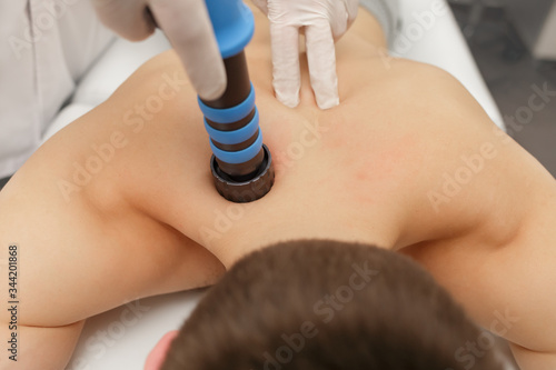 Extracorporeal Shockwave Therapy ESWT.Non-surgical treatment.Physical therapy for neck and back muscles,spine with shock waves.Pain relief, normalization and regeneration,stimulation healing process.