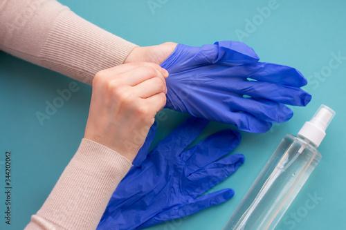 Top view of hands wearing blue medical gloves for protection and self-hygeine.Concept of health care, self-hygiene and prevention of coronavirus spreading