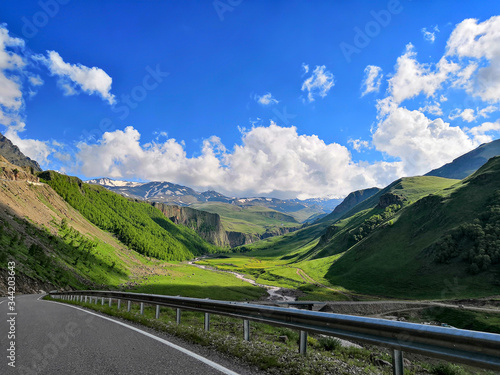 Mountain highway. The road through the mountains and gorges of the North Caucasus. View of the alpine mountains of the Caucasus in summer © MikeFrame