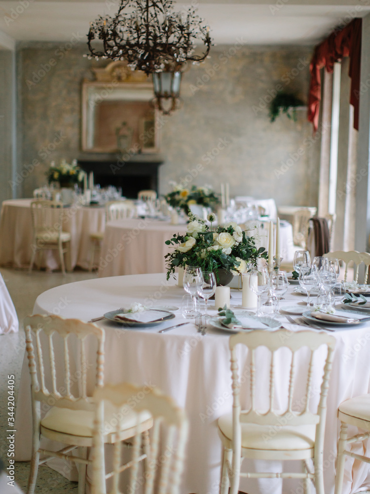wedding decor, served tables, ivory, with candles, glasses, beautiful wooden tables, inside the Italian old Villa
