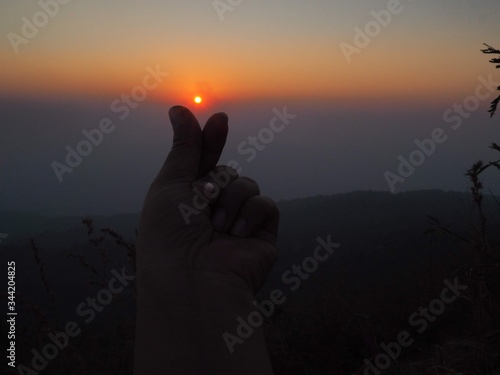 man praying in the sunset  © BUDSABA