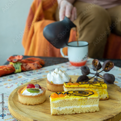 Cakes on a wooden tray and coffee ceramic turk