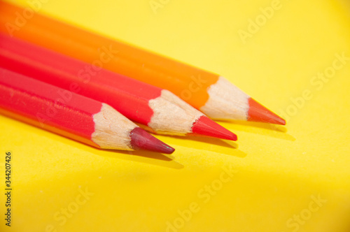colored pencils on a yellow background