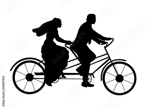 Silhouette of bride and groom on bicycle