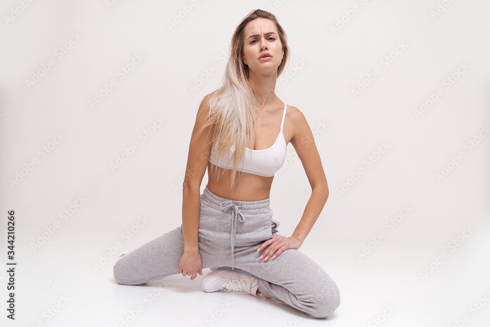 Pretty blonde woman in sport style look posing for camera, perfect style and so natural Pretty blonde woman in sport style look posing for camera, perfect style and so natural