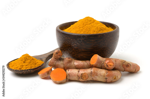 Turmeric (curcumin) powder and rhizomes isolated on a white background,Used for cooking and as herbal medicine,copy space.