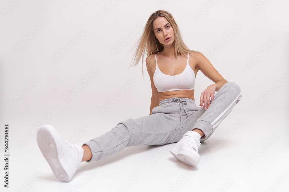 Pretty blonde woman in sport style look posing for camera, perfect style and so natural Pretty blonde woman in sport style look posing for camera, perfect style and so natural
