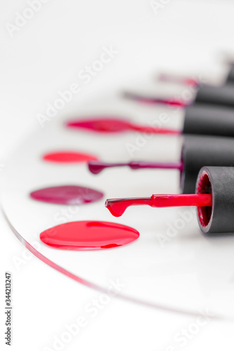 Red nail polish palette isolated on white.