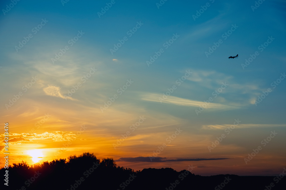 Airplane silhouette and beautiful sunset