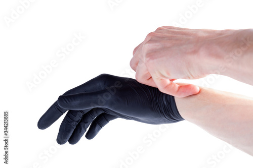 Φωτογραφία Man safely removing, taking off black protective disposable medical rubber gloves hand gesture, isolated on white, cut out, closeup