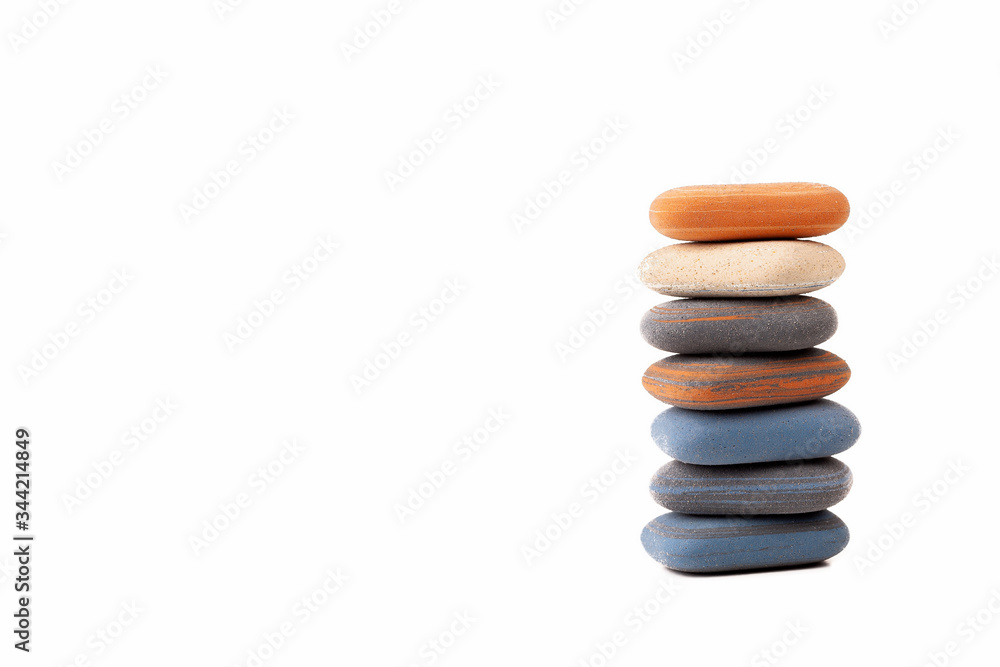 A pile, stack, tower of spa stones, simple treatment zen scene abstract symbol, copy space background. Rubber like zen pebbles isolated on white, minimalistic backdrop. Peace and tranqulity concept A pile, stack, tower of spa stones, simple treatment zen scene abstract symbol, copy space background. Rubber like zen pebbles isolated on white, minimalistic backdrop. Peace and tranqulity concept