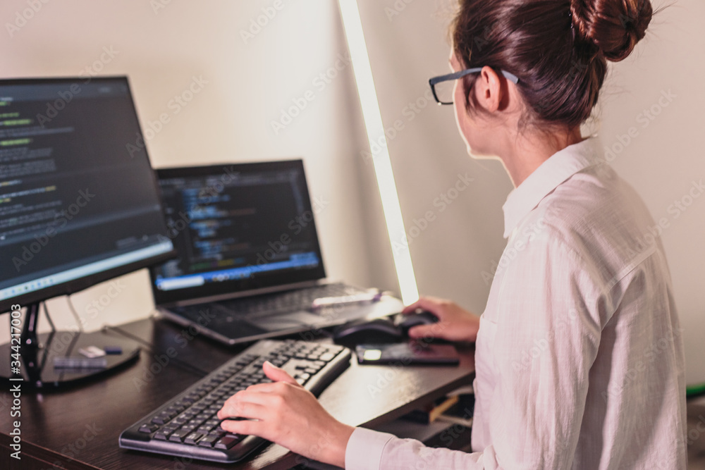 The programmer girl works at the computer. Information technology by the hands of women. Women in business. The girl works from home. The programmer girl works at the computer. Information technology by the hands of women. Women in business. The girl works from home.