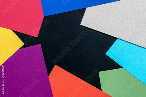 Multi-colored abstract geometric background. Colored sheets of paper on a black background. Trending colors 2020.