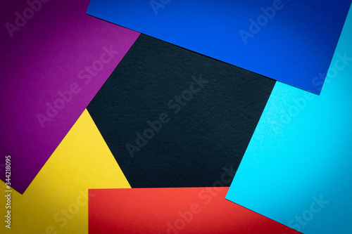 Multi-colored abstract geometric background. Colored sheets of paper on a dark background. Trending colors 2020.