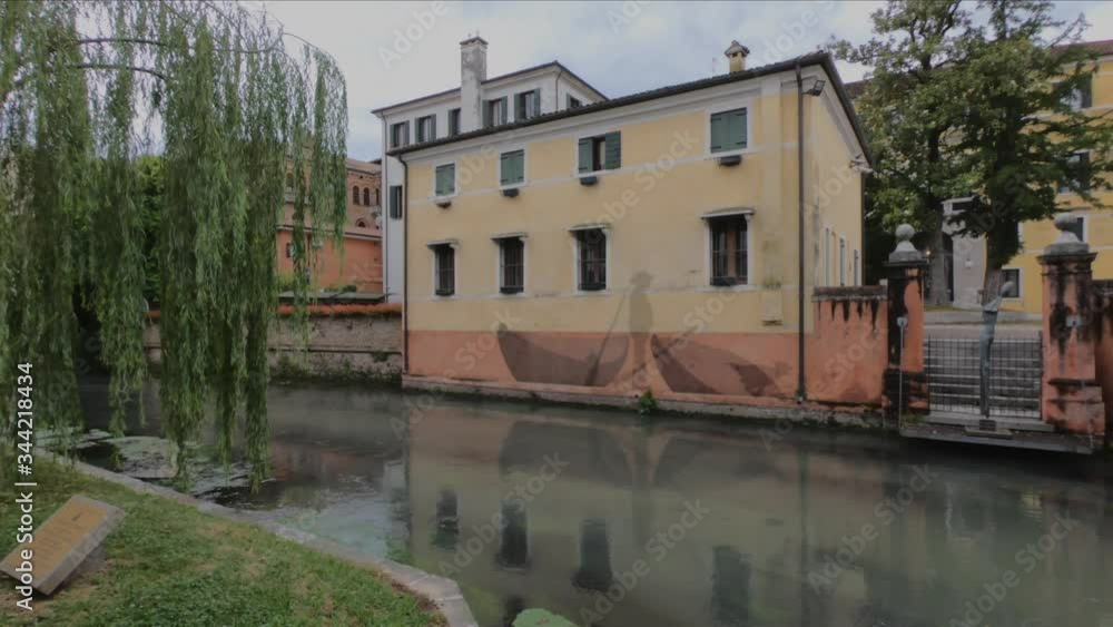 PAN SHOT - The Buranelli Canal is named after the merchants from Burano who lived along this watercourse in the 1500s, Treviso, Veneto, Italy. PAN SHOT - The Buranelli Canal is named after the merchants from Burano who lived along this watercourse in the 1500s, Treviso, Veneto, Italy.