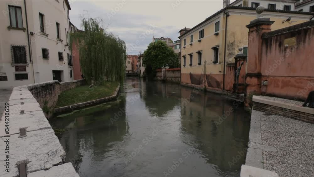 SHOT SLOW MOTION - The Buranelli Canal is named after the merchants from Burano who lived along this watercourse in the 1500s, Treviso, Veneto, Italy. SHOT SLOW MOTION - The Buranelli Canal is named after the merchants from Burano who lived along this watercourse in the 1500s, Treviso, Veneto, Italy.