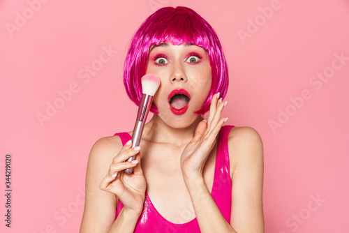 Image of nice girl expressing surprise and holding powder brush