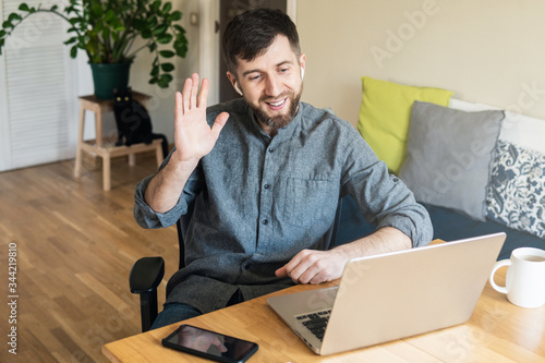 Handsome Eastern European man working from home during Corona virus quarantine