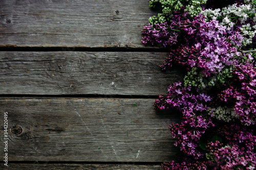 Lilac flowers on a wooden background. Free space