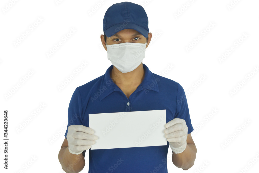 Portrait of delivery man wearing medical mask and medical gloves and holding blank paper mockup on white background. Concept for delivery services courier during the Coronavirus (COVID-19) pandemic. Portrait of delivery man wearing medical mask and medical gloves and holding blank paper mockup on white background. Concept for delivery services courier during the Coronavirus (COVID-19) pandemic.