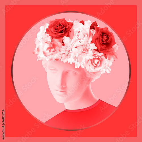 Beautiful young female red face and colorful flowers. Plaster antique bust of Venus in a floral wreath. Beauty spring and summer model girl with fresh bouquet. © Ded Pixto