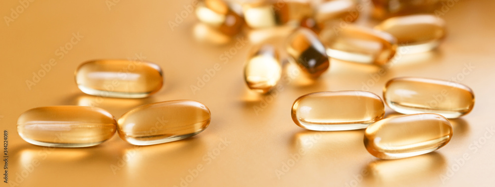 Many capsules Omega 3 on yellow background. Close up, high resolution product. Health care concept. Many capsules Omega 3 on yellow background. Close up, high resolution product. Health care concept.