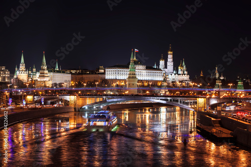 View of Moscow at night with a panorama of the Moscow Kremlin and a large stone bridge over the Moscow river. Moscow, Russia