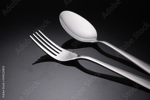 Fork and spoon, fork and spoon on black background