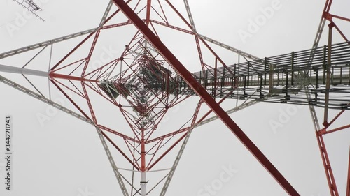 Under and rotation of Tower for telecommunications television broadcast cell phone or radio and satellite on the mountain peak. Slow Motion 4K 29.97fps