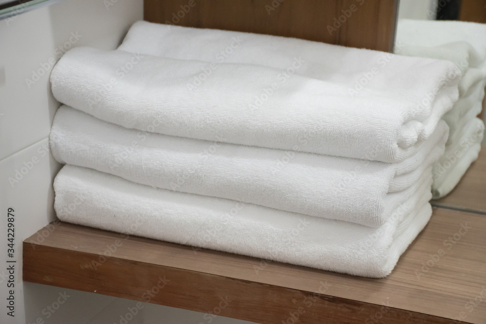 Folding white towel in bathroom in the resort Folding white towel in bathroom in the resort