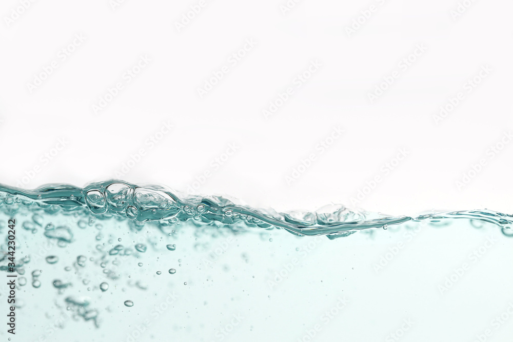 Close up water splash with air bubbles. Fresh and clean surface aqua flowing in wave and clean water on white background isolated. Advertising image with free space for your work