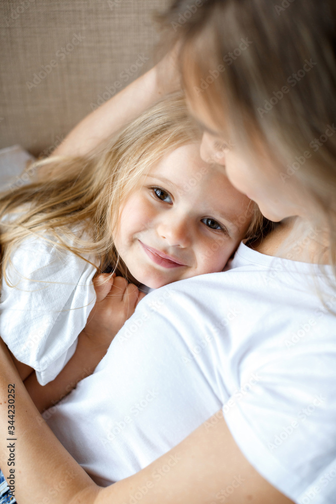 Mother's love. Mom hugs her little daughter. Maternal hugs. Female portraits close-up. The concept of female happiness Mother's love. Mom hugs her little daughter. Maternal hugs. Female portraits close-up. The concept of female happiness